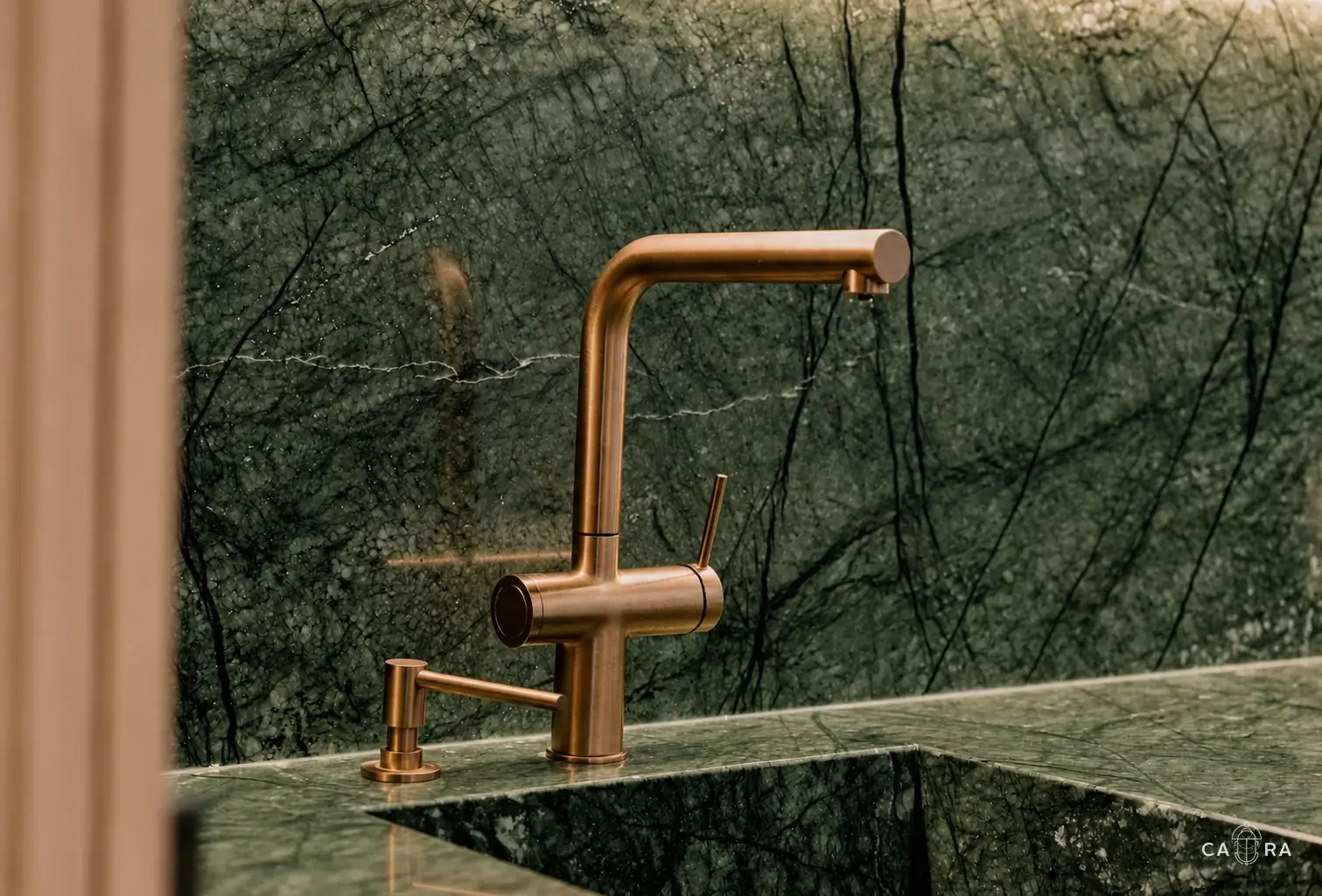 Bronze tap and green marble detail