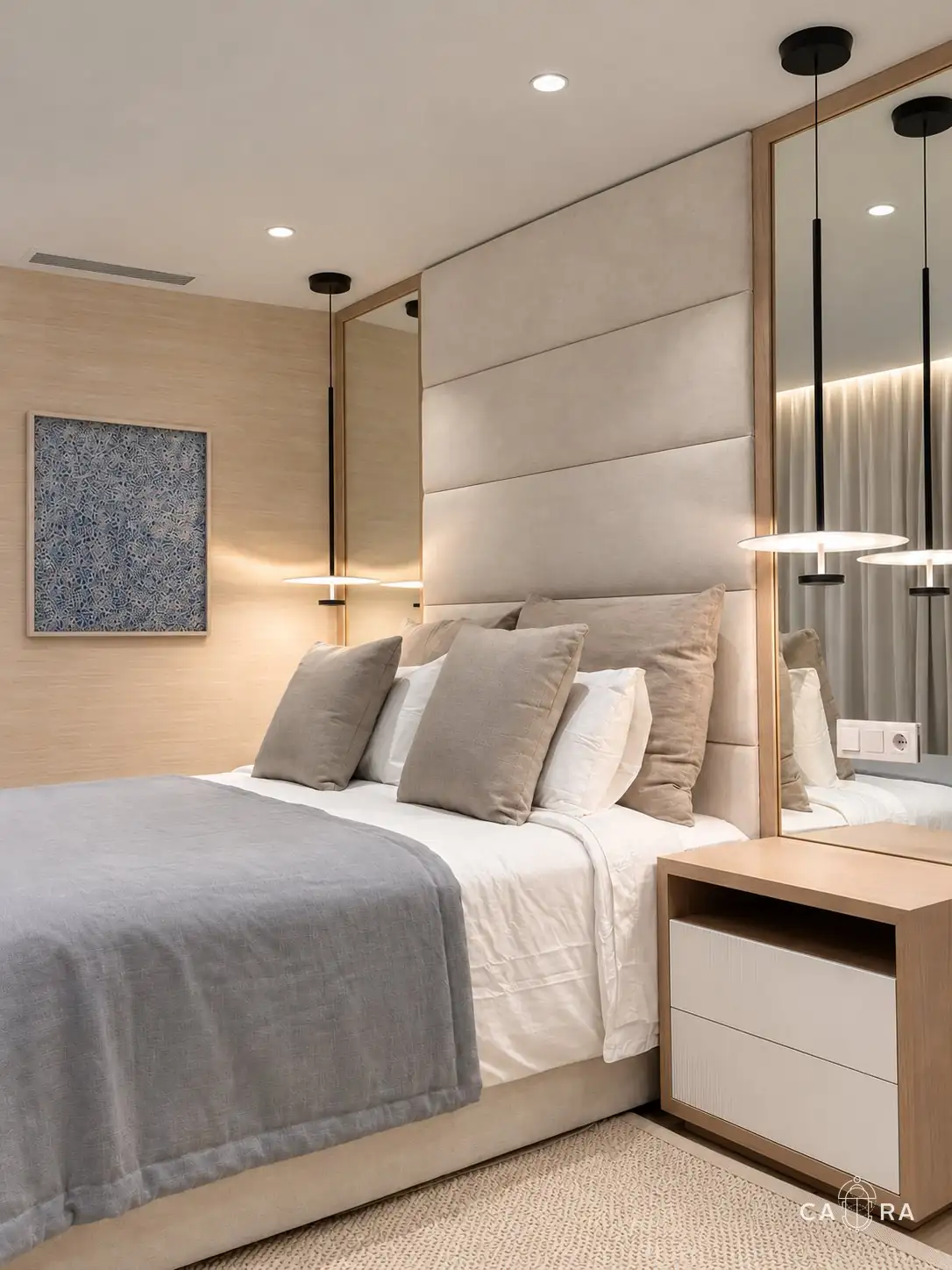 Bedside table and pendant lights reflected in the mirror