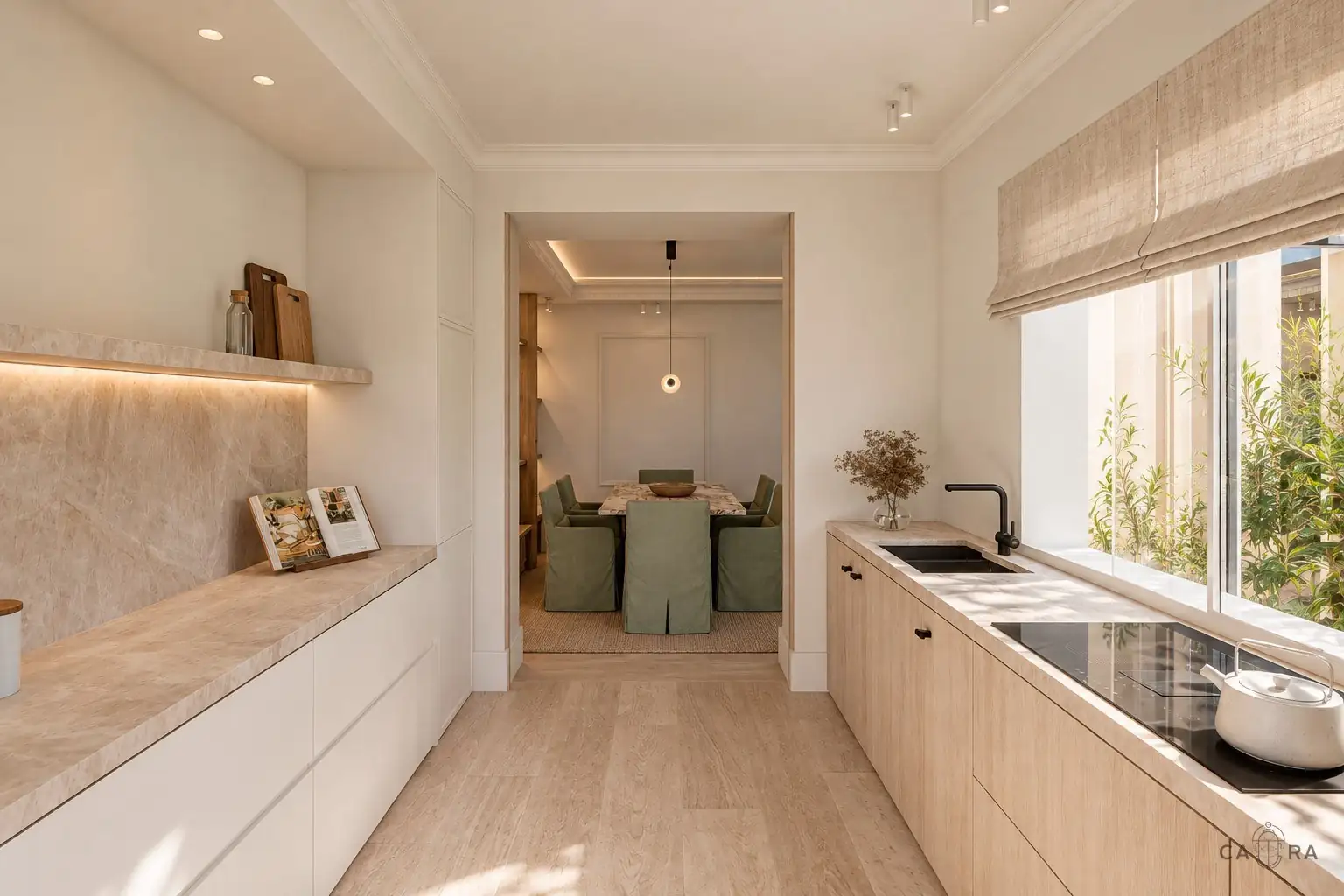 Kitchen in pale stone and oak opening onto a dining room, by Cara Studio