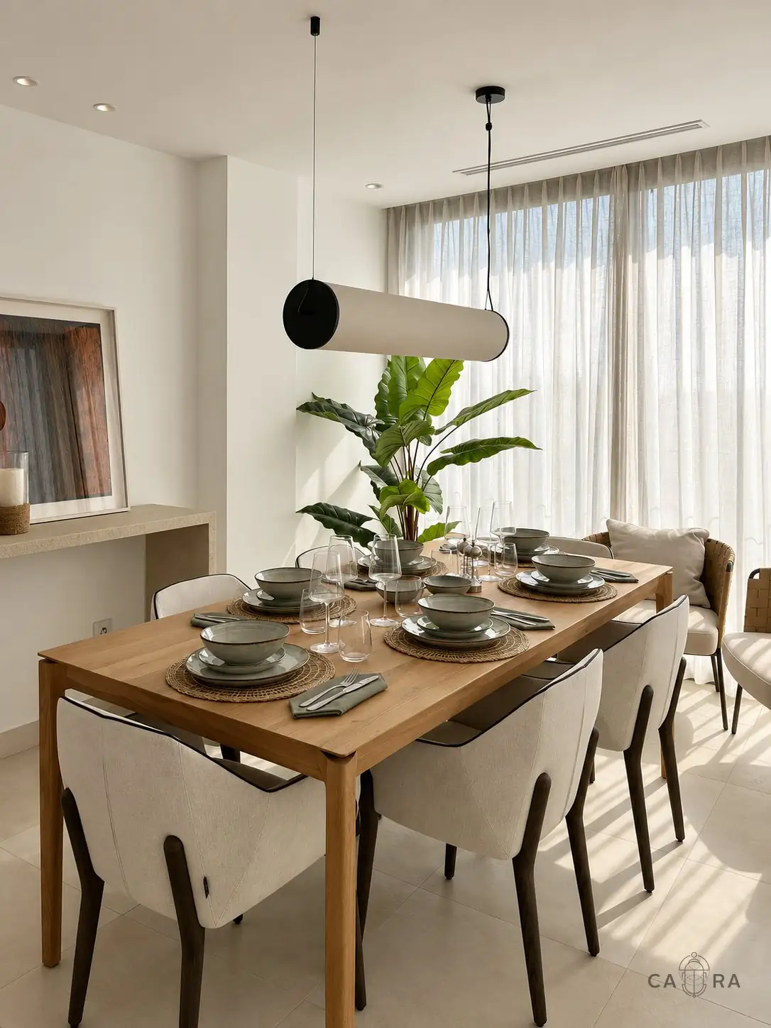 Dining table laid with ceramics under a linen pendant