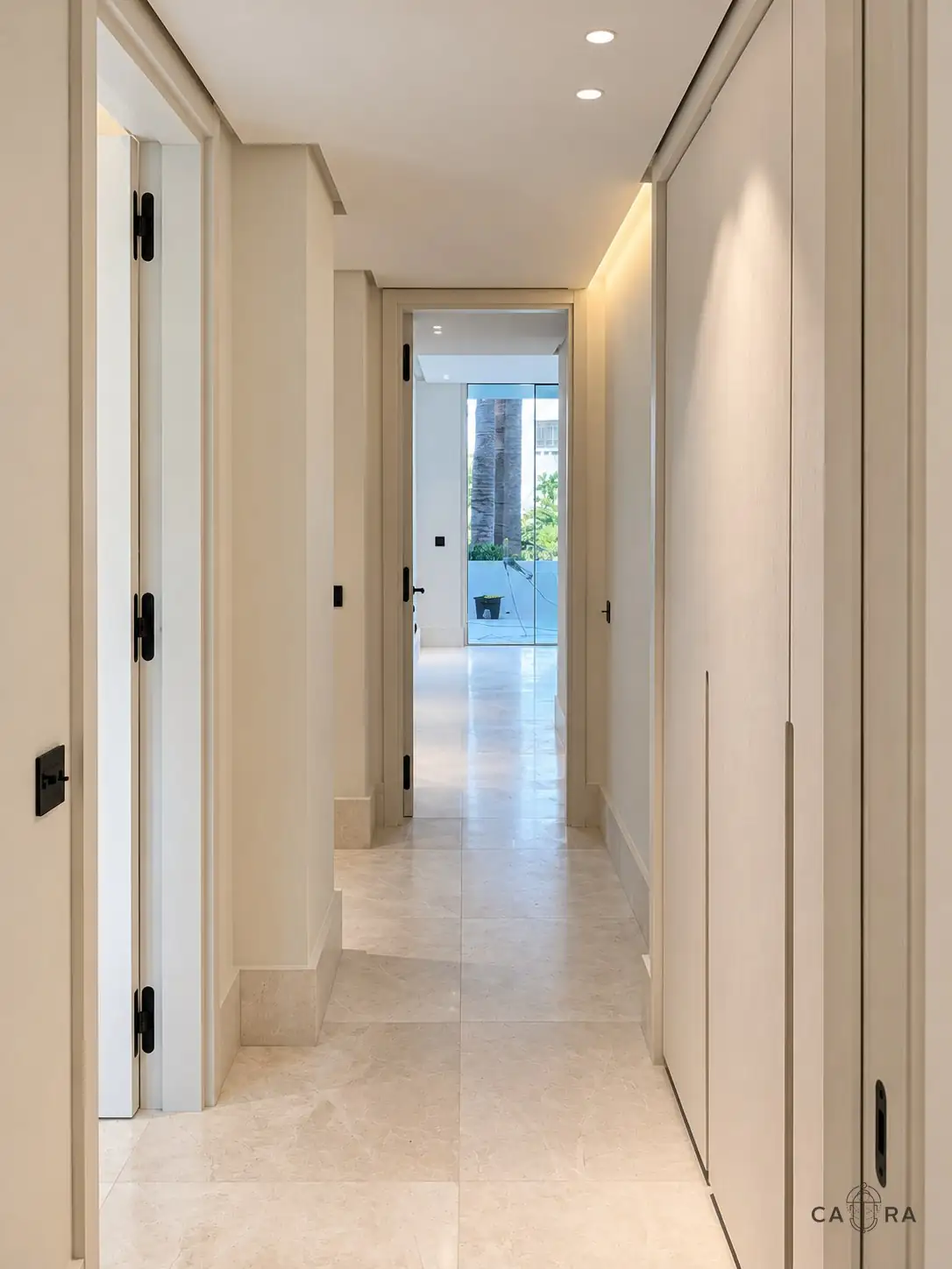Corridor with stone floor and flush panelled storage