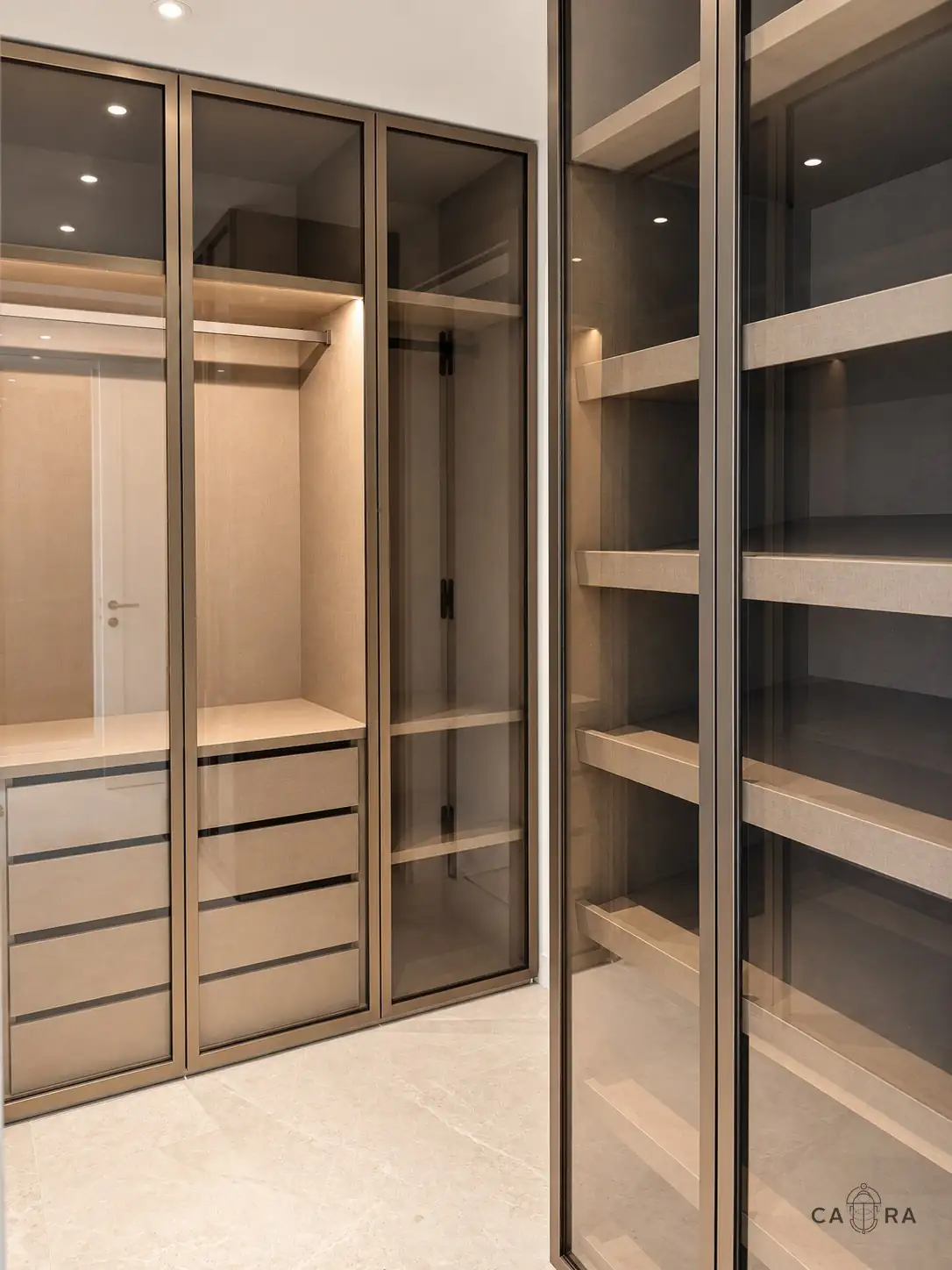 Walk-in wardrobe with bronze-framed smoked glass doors
